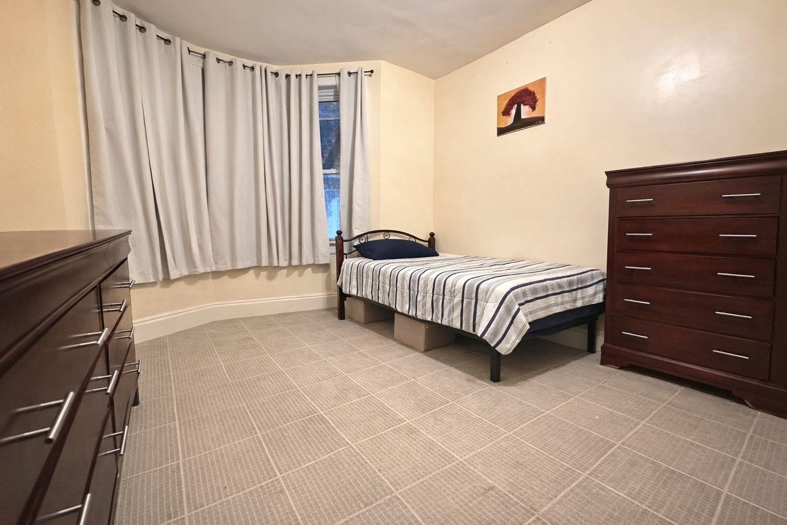 811 24th Street Union City, NJ 07087 - Photo 4 of 4 a spacious bedroom with a bed and a cabinets