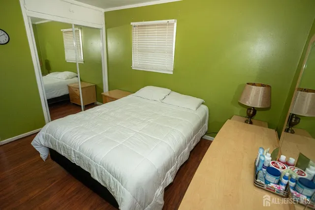 a bedroom with a bed and mirror