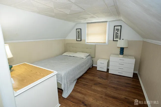 a bedroom with a bed and a night stand