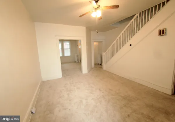a view of an empty room with a fireplace