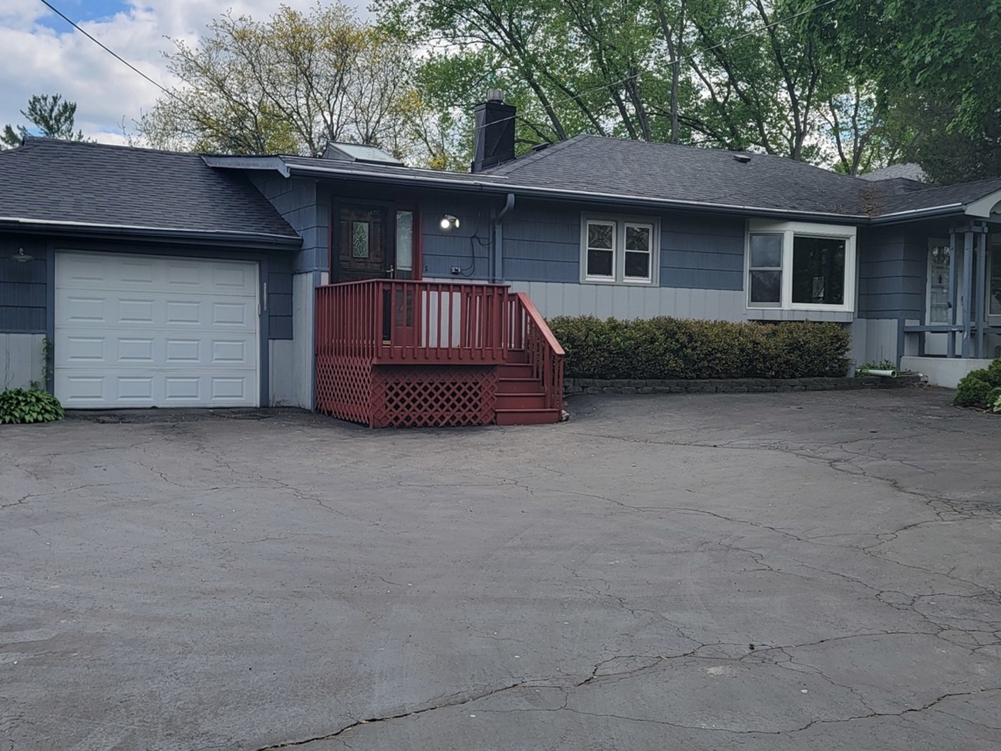 24049 West Grass Lake Road Antioch, IL 60002 - Photo 1 of 26 a front view of a house with a garden and trees