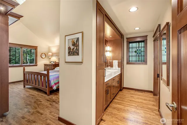 a view of a hallway with wooden floor and windows