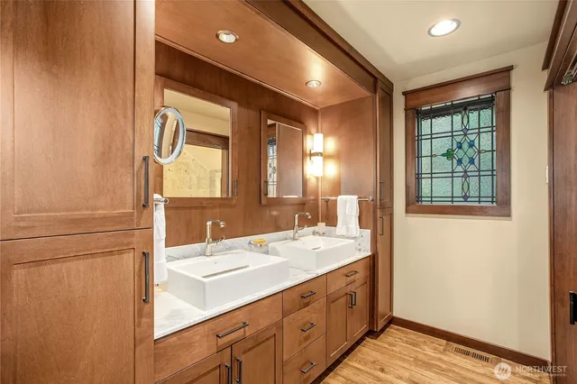 a bathroom with a double vanity sink and a mirror