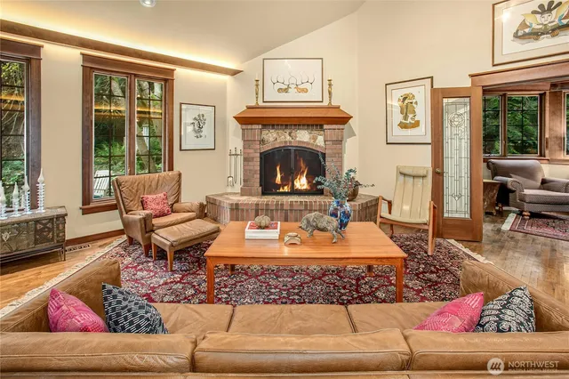 a living room with furniture a rug and a fireplace