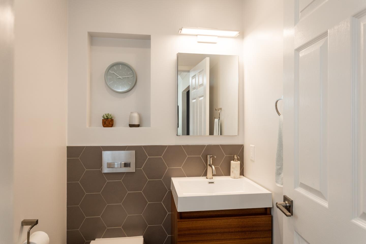 560 Macarthur Drive Daly City, CA 94015 - Photo 15 of 18 a bathroom with a sink and a mirror