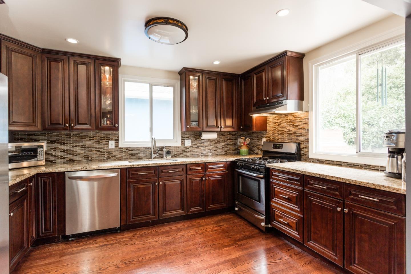 560 Macarthur Drive Daly City, CA 94015 - Photo 9 of 18 a kitchen with stainless steel appliances granite countertop wooden cabinets a sink dishwasher a stove and a refrigerator
