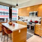 a kitchen with stainless steel appliances granite countertop a sink a stove and a refrigerator