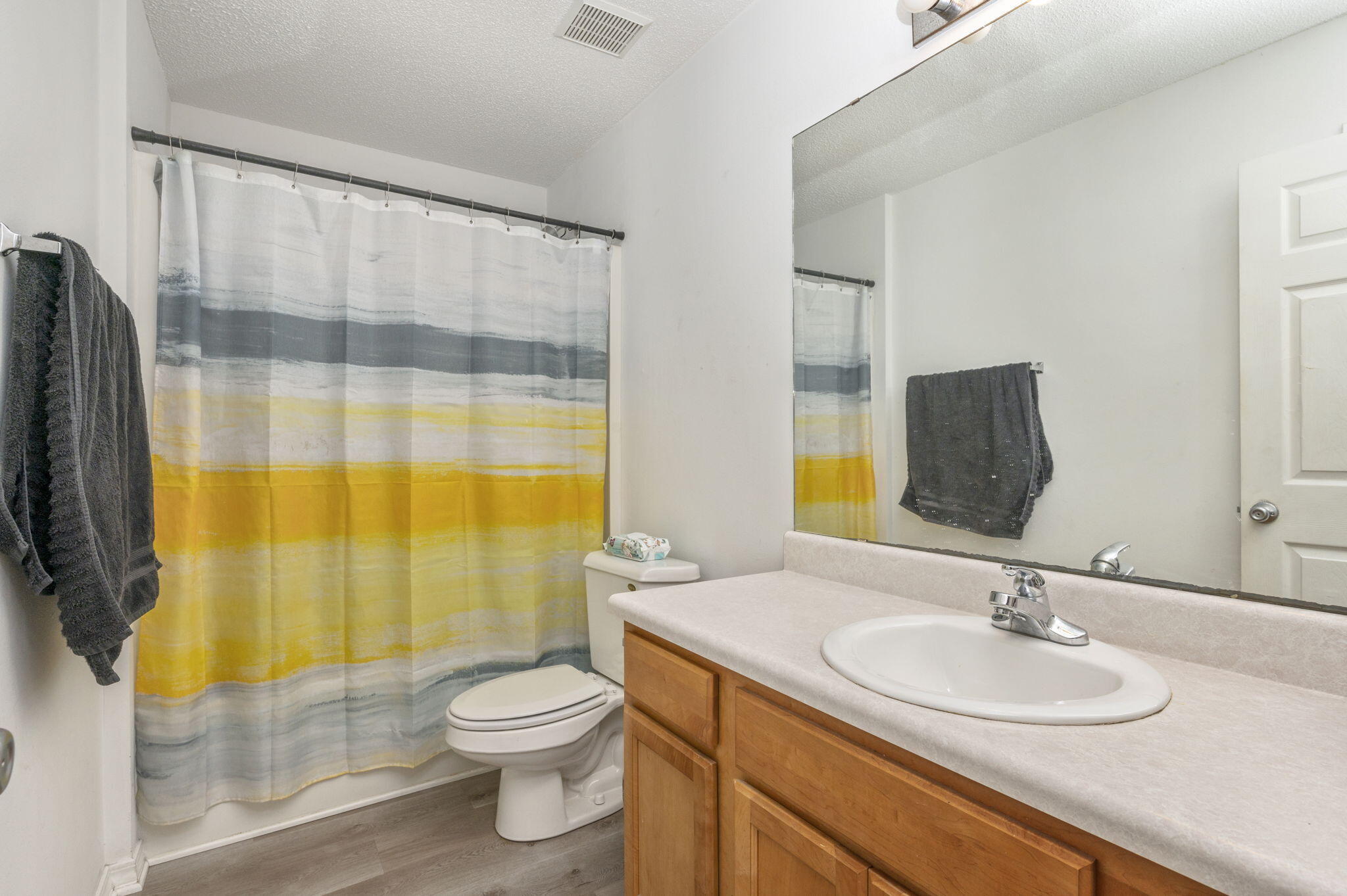 2139 Tom Street Navarre, FL 32566 - Photo 11 of 32 a bathroom with a sink a toilet and shower curtain