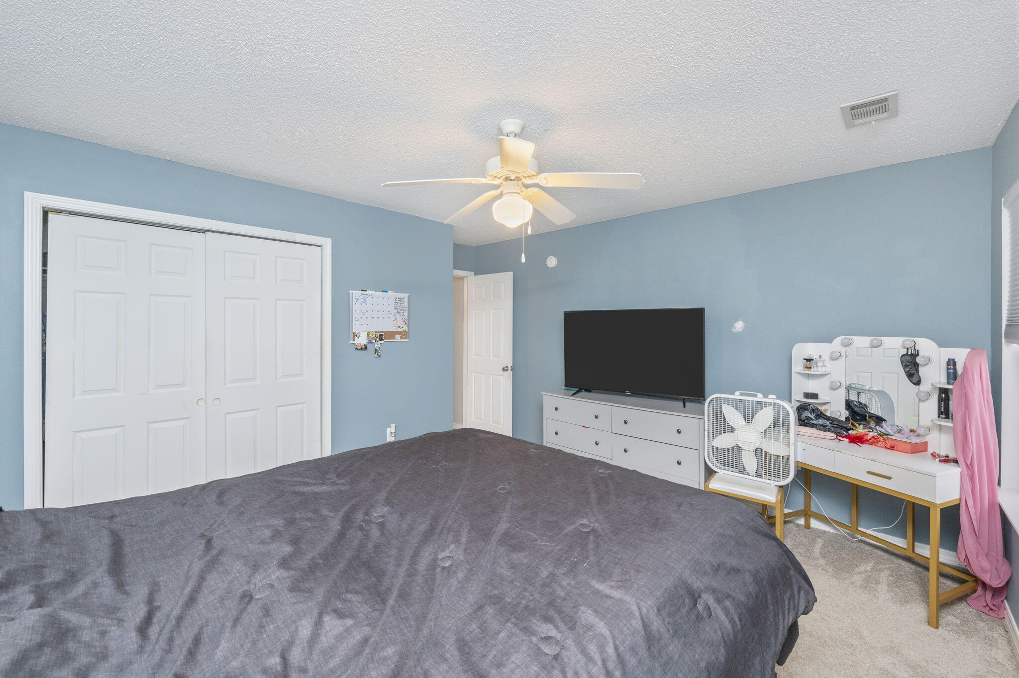 2139 Tom Street Navarre, FL 32566 - Photo 13 of 32 a bedroom with a bed and a flat screen tv