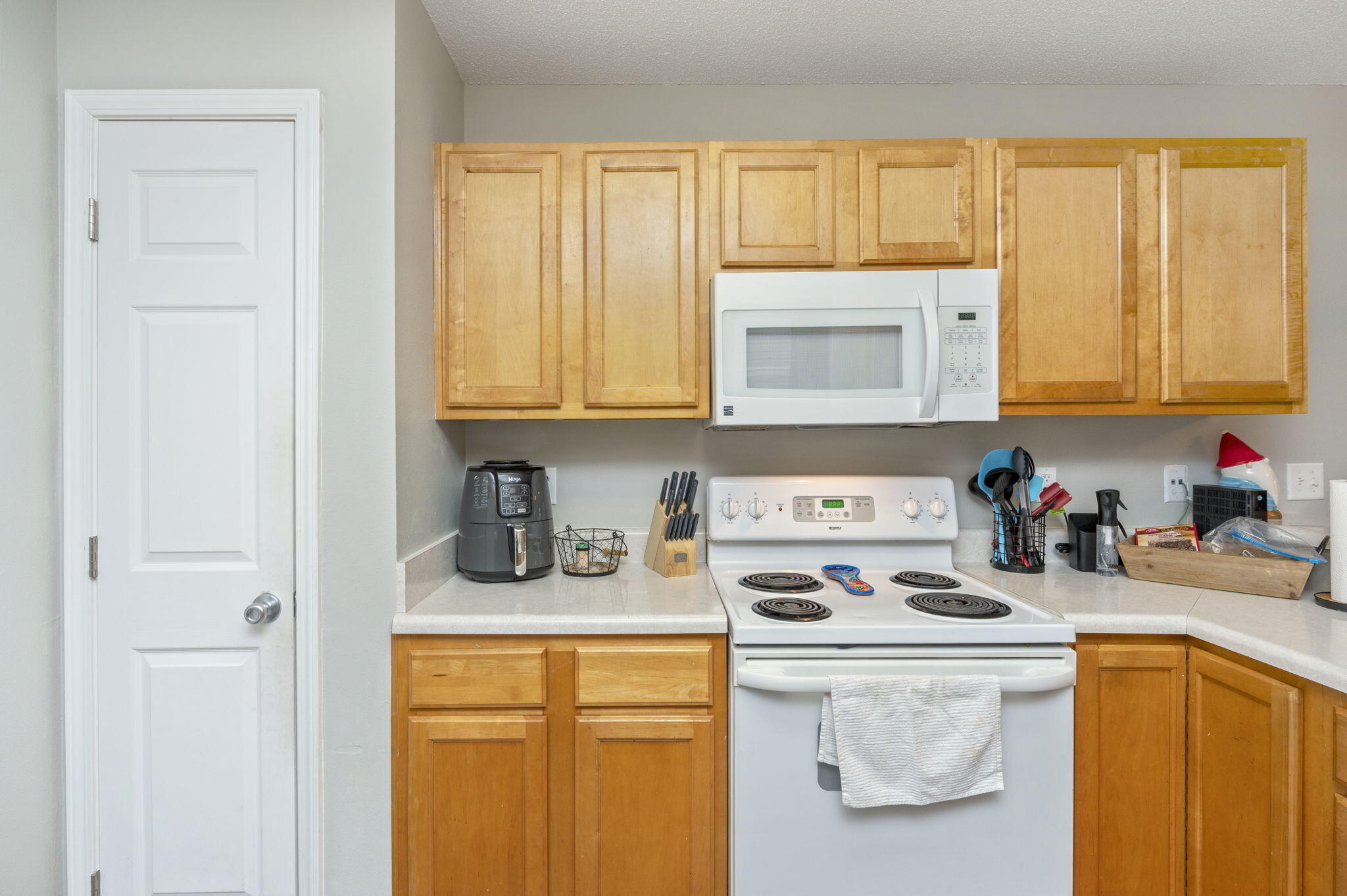 2139 Tom Street Navarre, FL 32566 - Photo 18 of 32 a kitchen with a sink a stove and cabinets