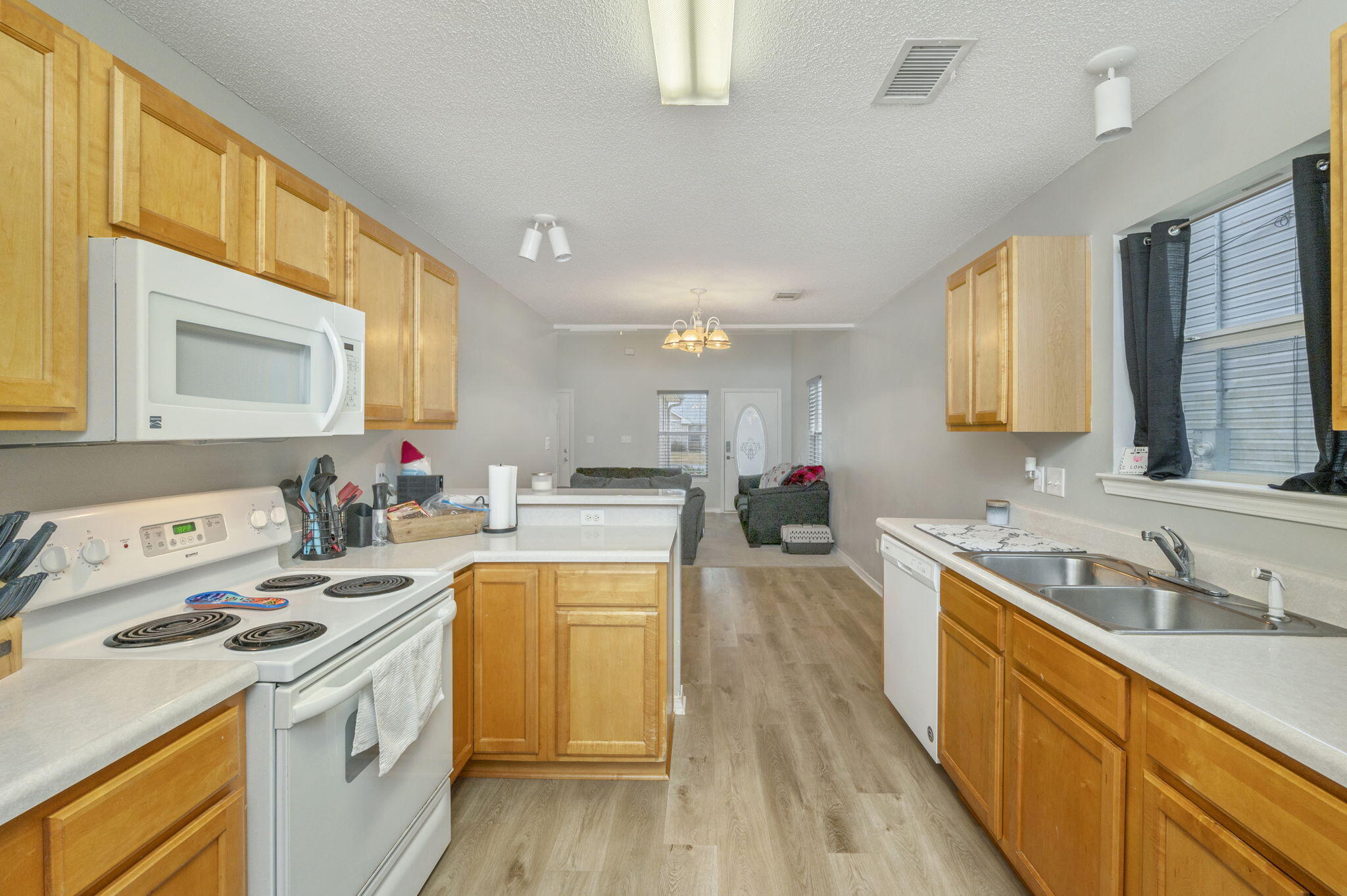 2139 Tom Street Navarre, FL 32566 - Photo 19 of 32 a kitchen with a sink a stove and cabinets