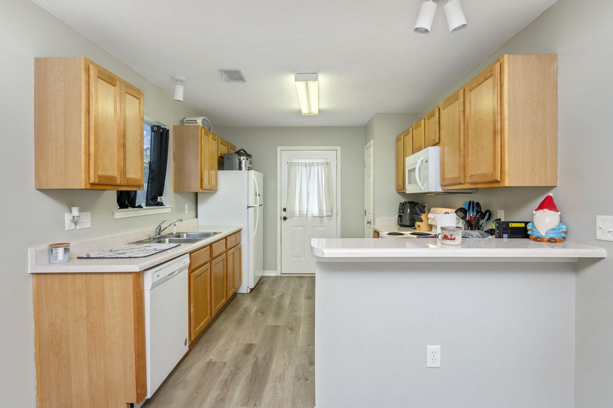 2139 Tom Street Navarre, FL 32566 - Photo 22 of 32 a kitchen with kitchen island granite countertop a sink and cabinets