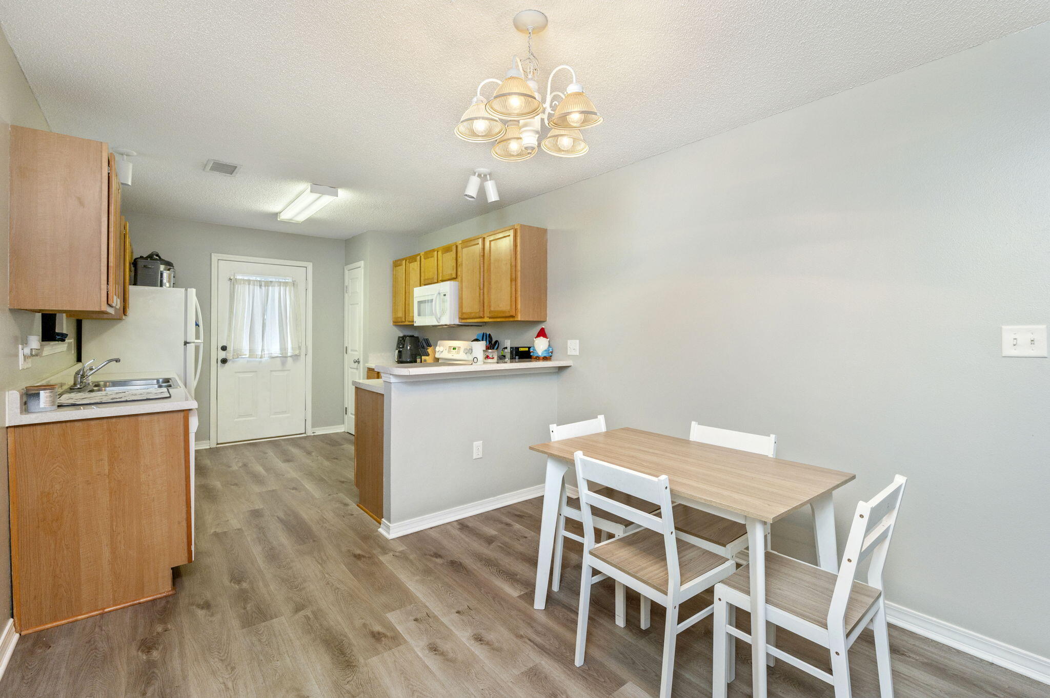2139 Tom Street Navarre, FL 32566 - Photo 23 of 32 a kitchen with a table and chairs in it