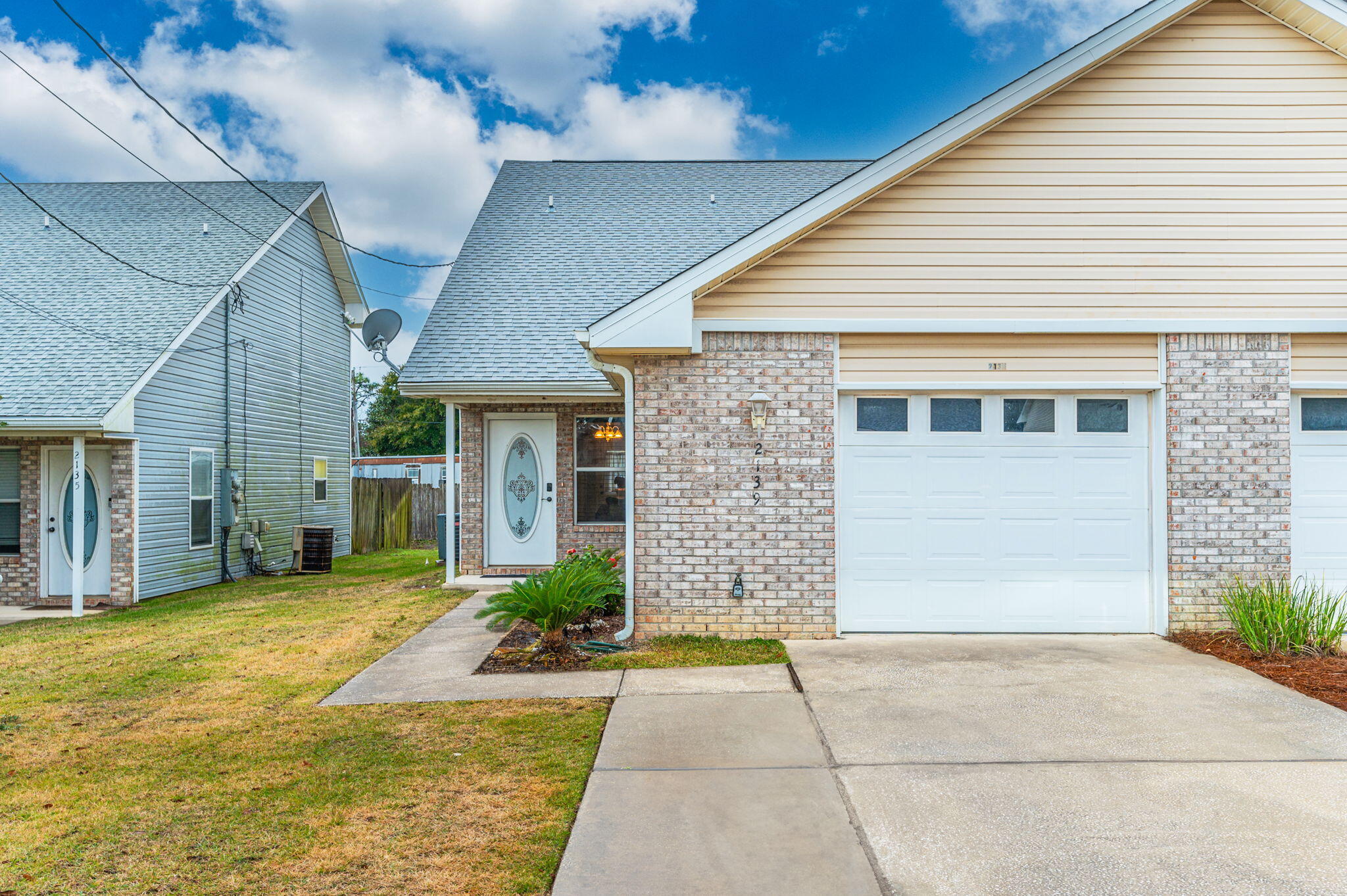 2139 Tom Street Navarre, FL 32566 - Photo 31 of 32 a front view of a house with a yard and garage