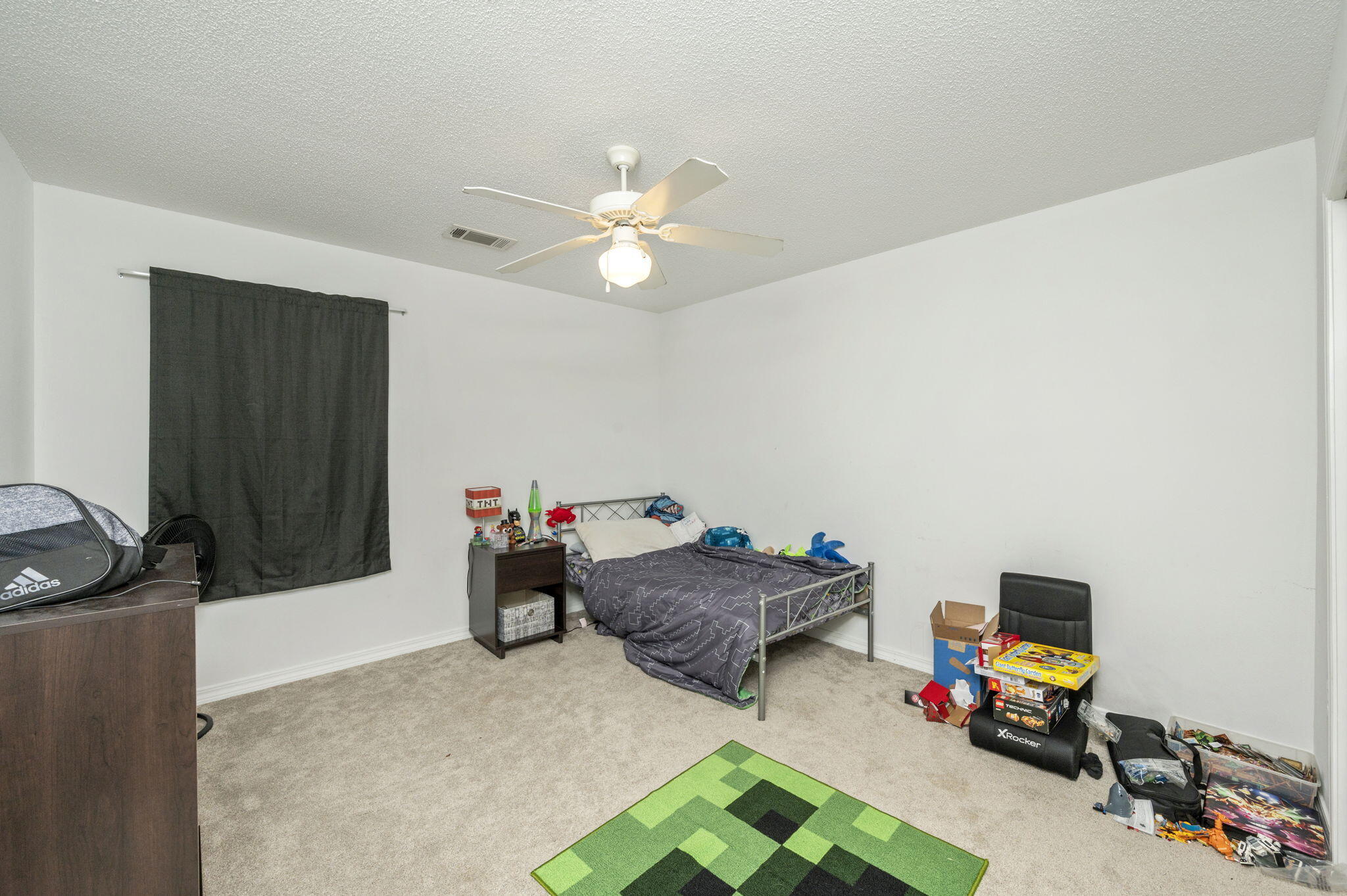 2139 Tom Street Navarre, FL 32566 - Photo 9 of 32 a bedroom with furniture and a chandelier