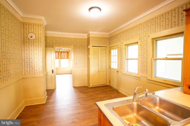 a bathroom with a tub a sink and a large window