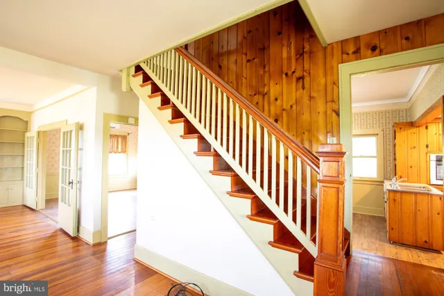 a view of an entryway with wooden floor
