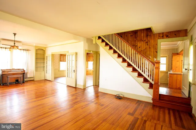 a view of livingroom with hardwood floor and stairs