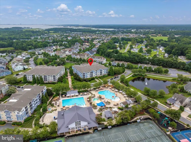 an aerial view of residential houses with outdoor space and a lake view