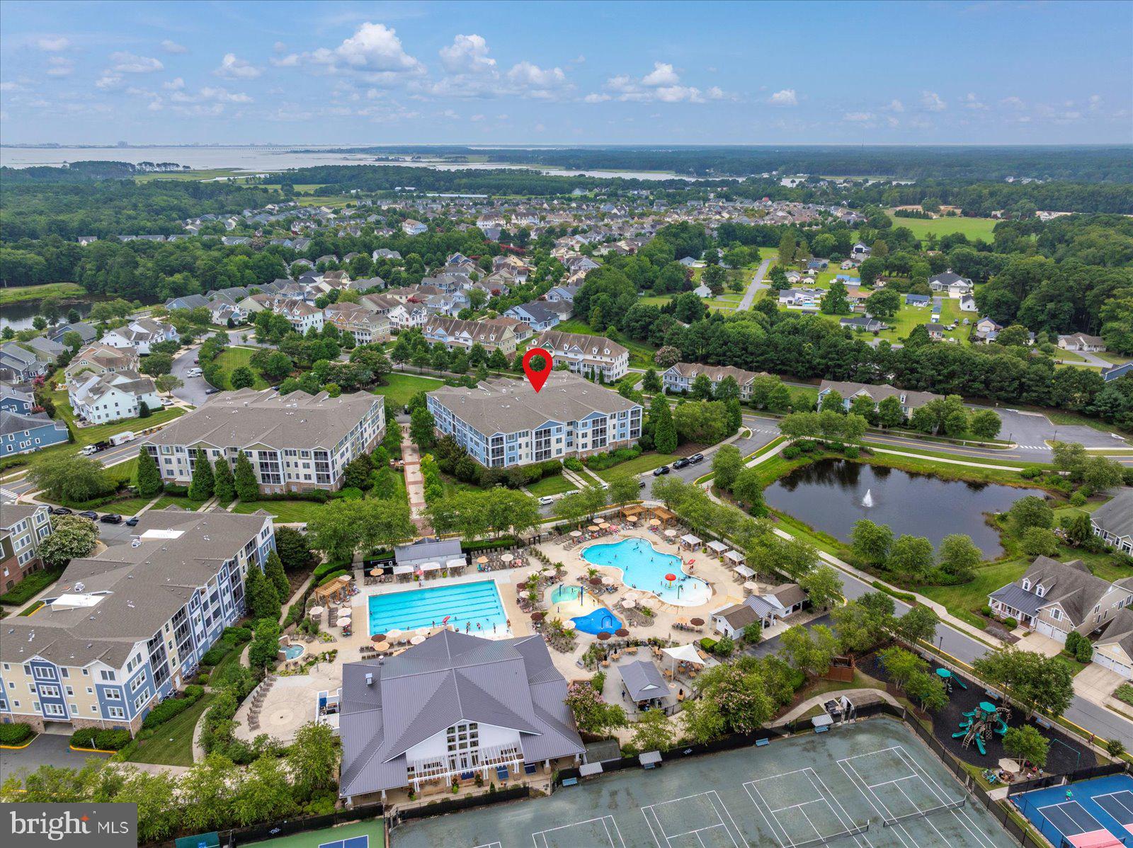 an aerial view of residential houses with outdoor space and a lake view