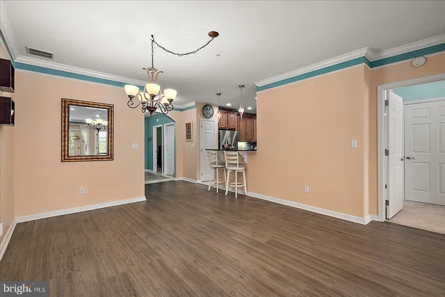 a bedroom with a bed and painting on the wall