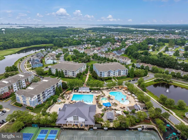 a view of a hallway with wooden floor and a living room