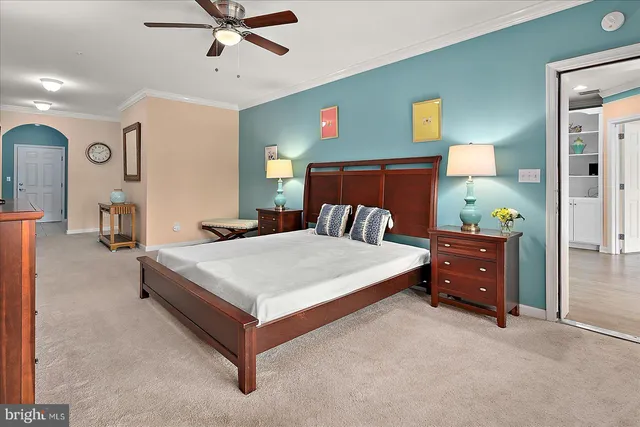 a living room with lots of furniture and a kitchen view