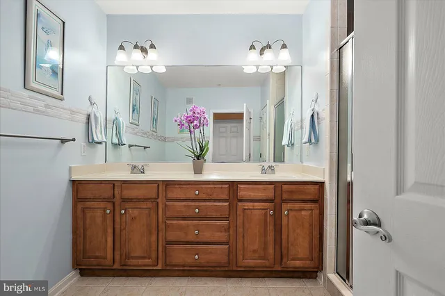 a front view of a house with a yard and potted plants
