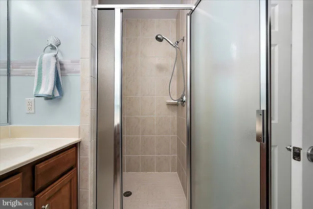 a front view of a house with glass windows and plants