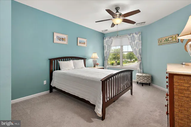 a view of a lake with a yard and large trees