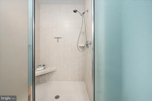 a street sign on a wall next to a road