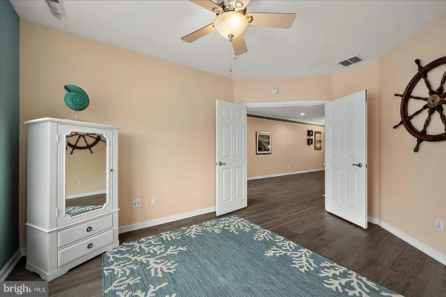 an aerial view of a city with lots of residential buildings ocean and mountain view in back