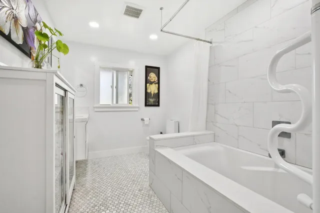 a bathroom with a bathtub and a sink
