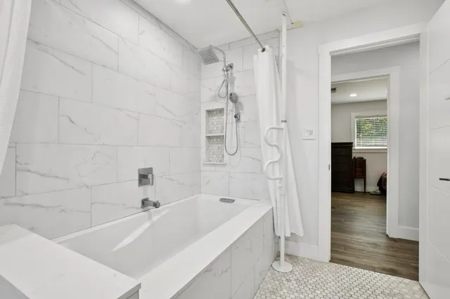 a bathroom with a bathtub and a shower