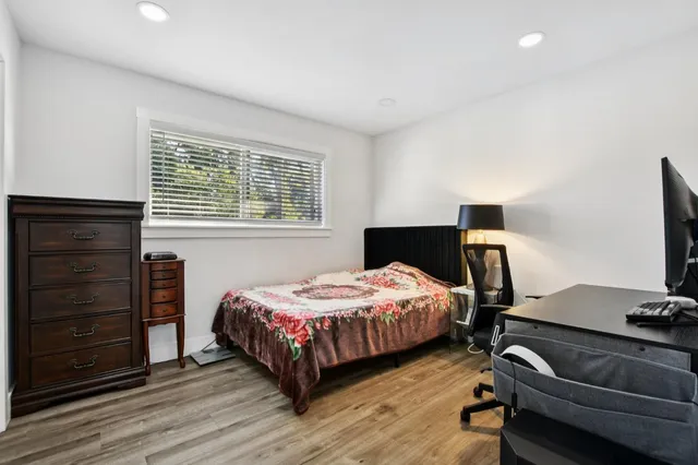 a bedroom with a bed and a flat tv screen