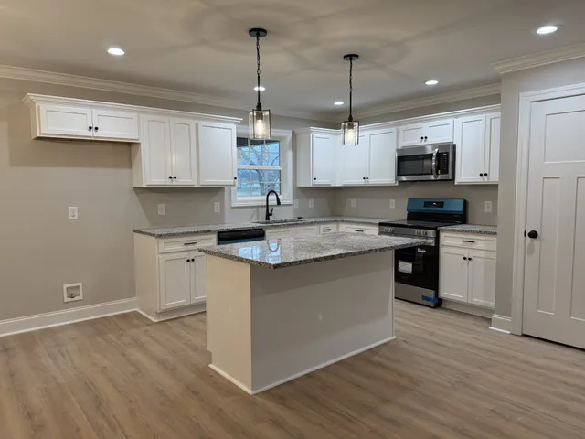 a kitchen with granite countertop a sink and dishwasher