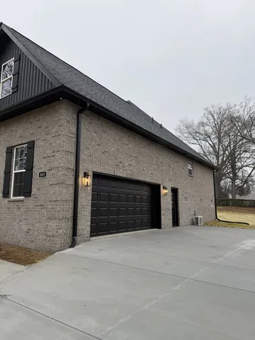 a view of a livingroom with wooden floor and a ceiling fan