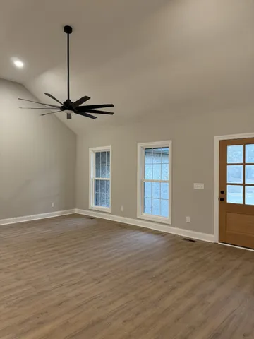 a view of a kitchen with wooden floor and a sink