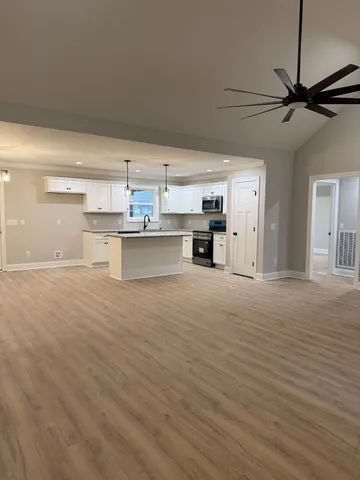 a view of a kitchen with a sink and cabinets