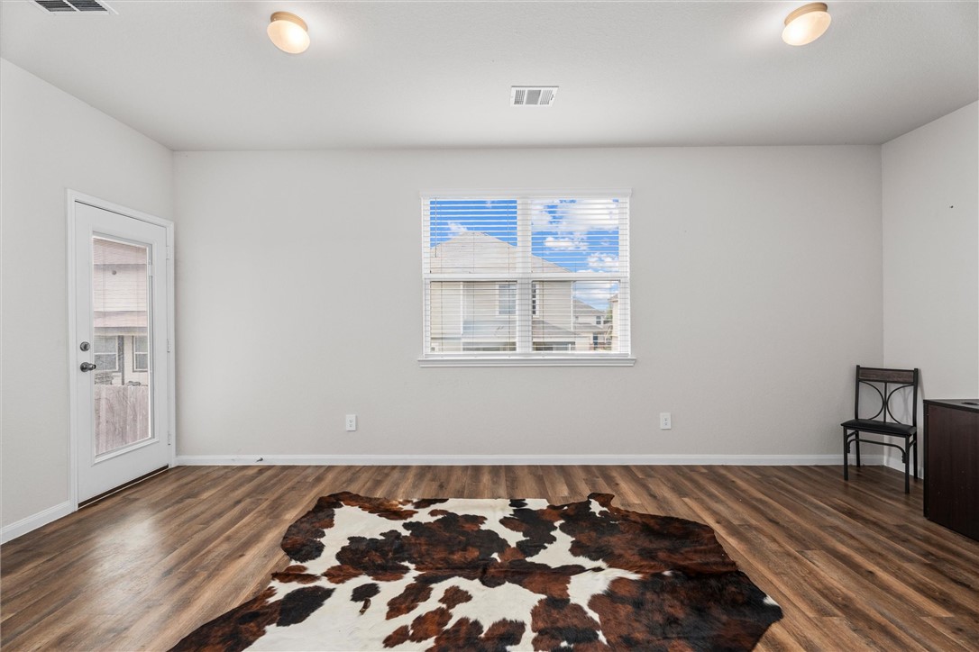 980 Rice Drive Bryan, TX 77803 - Photo 12 of 31 a bed sitting in a bedroom next to a window and a chair