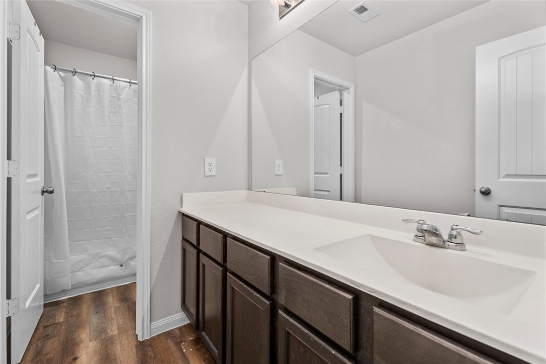 980 Rice Drive Bryan, TX 77803 - Photo 23 of 31 a bathroom with a sink and a mirror