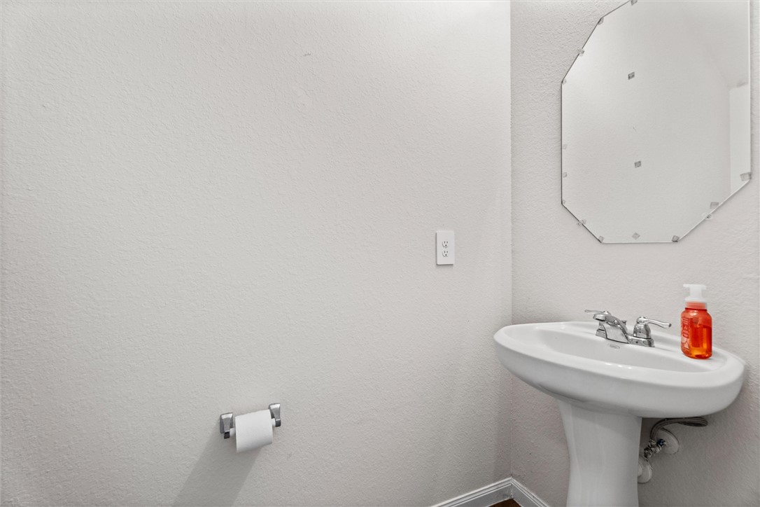 980 Rice Drive Bryan, TX 77803 - Photo 5 of 31 a bathroom with a sink and a mirror