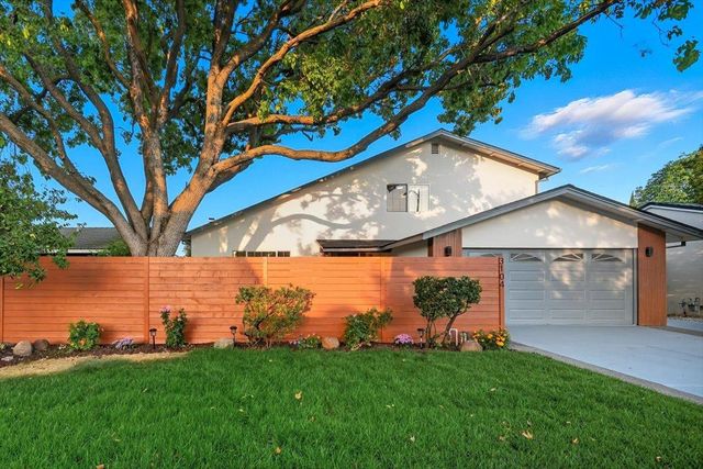 a view of a dining room with furniture a rug and wooden floor