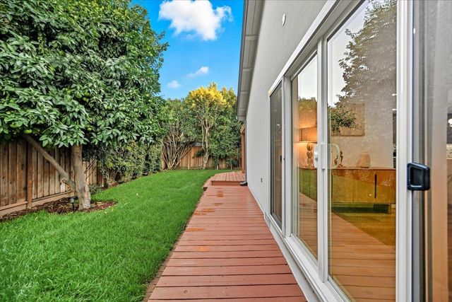 a spacious bedroom with a bed and wooden floor
