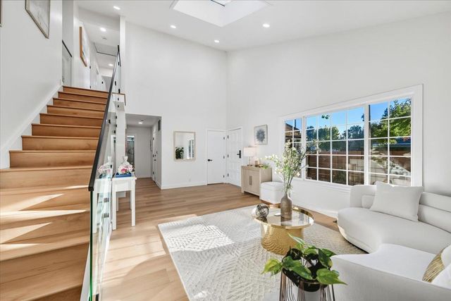 a bathroom with a granite countertop sink a mirror and a toilet