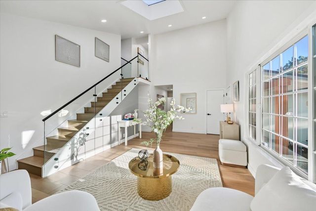 a spacious bathroom with a granite countertop sink and a mirror