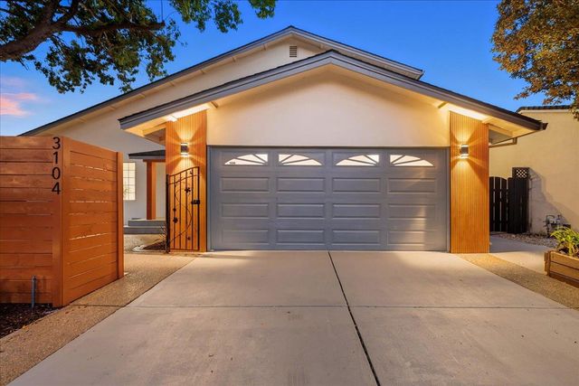 a backyard of a house with barbeque oven table and chairs
