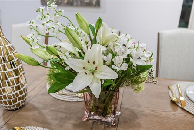 a front view of a house with a yard and tree s