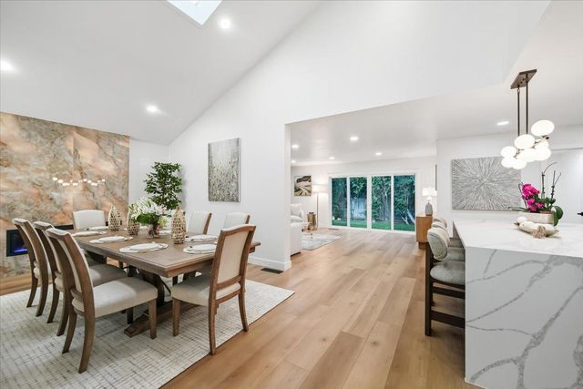 a front view of a house with a yard and tree s