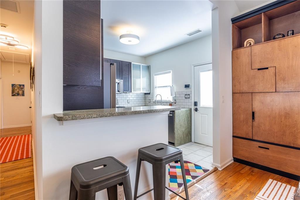 69 Randolph Street Northeast, Unit A Atlanta, GA 30312 - Photo 18 of 50 a view of a kitchen with fridge and wooden floor